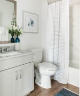 A white toilet sits next to a sink in a bathroom at Villas of Mason Hills, Leander