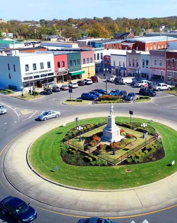 A city square with a monument in the middle of it.