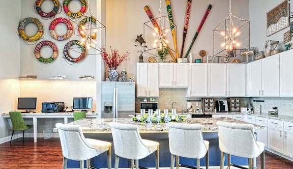 a kitchen with white cabinets and a table with chairs