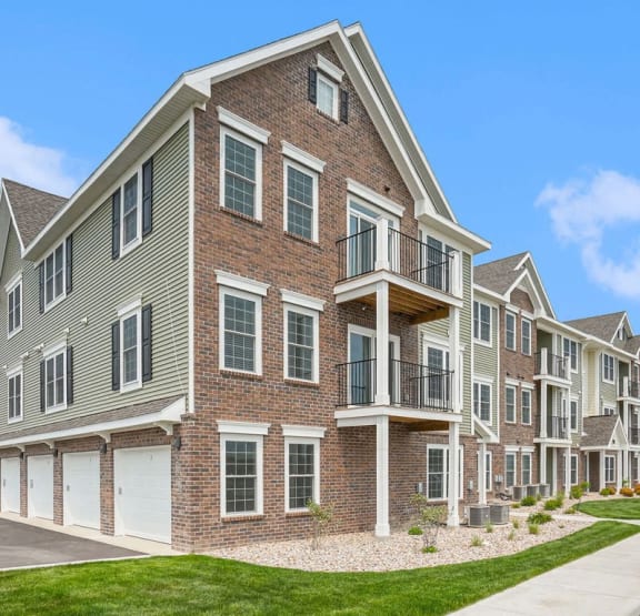 an exterior apartment building with balconies and garages at Meadowbrooke Apartment Homes, Grand Rapids, MI