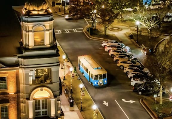 A bus is driving down a street at night.