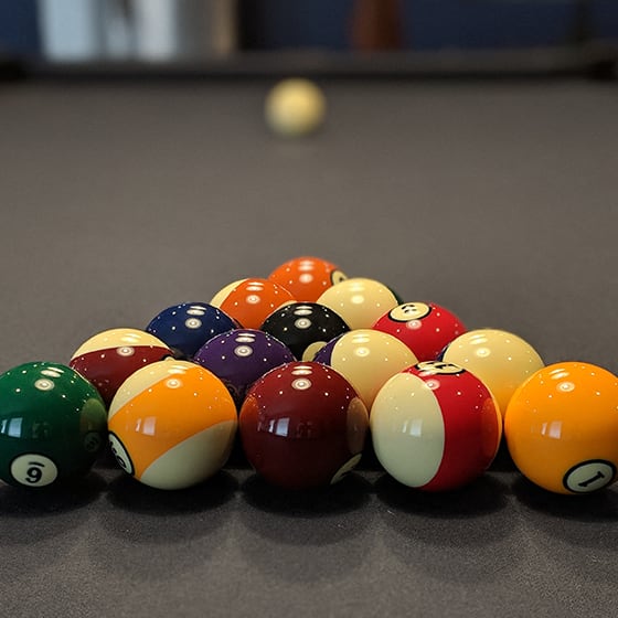 a pile of billiard balls on a pool table at Upscale Living at the Grand off 45th, Fargo, North Dakota