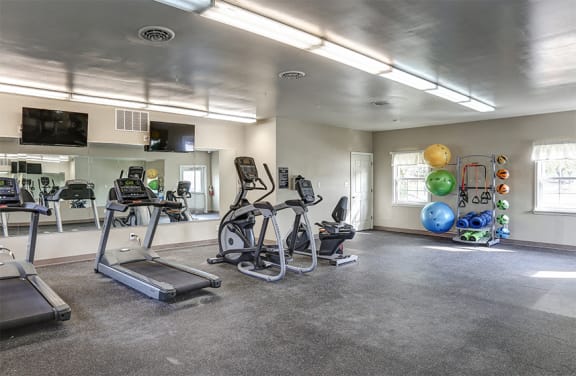 Fitness Center with cardio machines and yoga area.