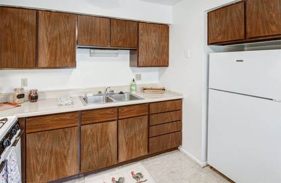 Kitchen at Carriage House East with white appliances and plenty of cabinetry.