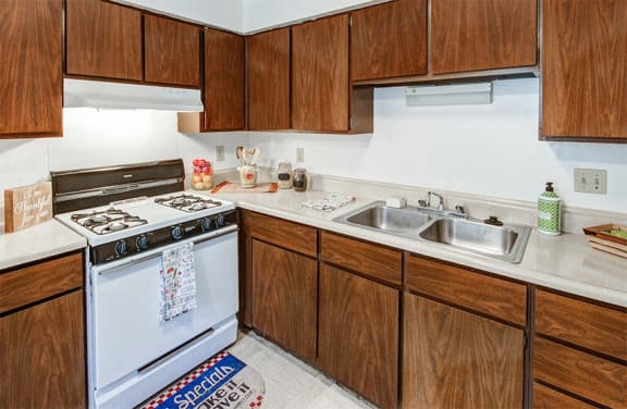 Kitchen with white appliances and plenty of cabinetry for food and kitchen utensil storage