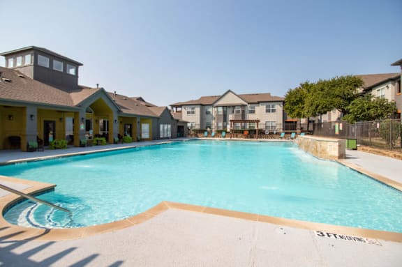 A large swimming pool in front of apartment buildings at Walker Place Apartments, Texas, 76643