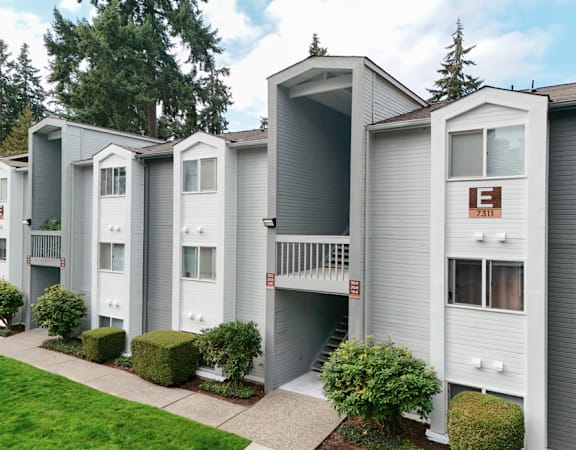 Apartment complex with a green lawn in front.