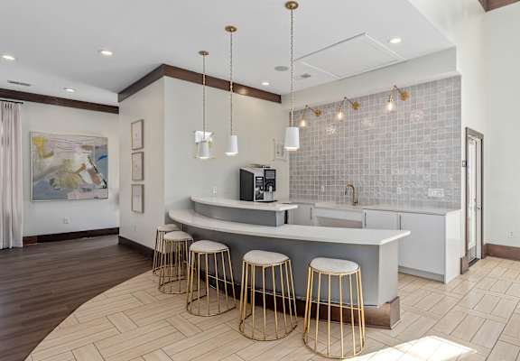 A kitchen with a bar area and a painting on the wall.