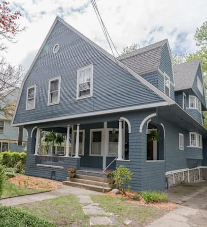 a blue house with white trim and white windows