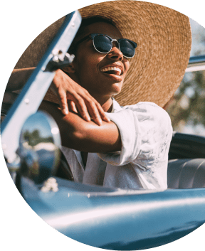 a woman sitting in a car with her hat and sunglasses at Paramount on Lake Eola, Florida, 32801