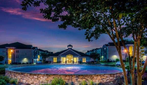 the swimming pool at night at the resort at governors crossing