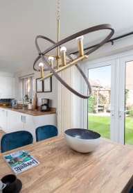 a bedroom with a bed and a chair in a room