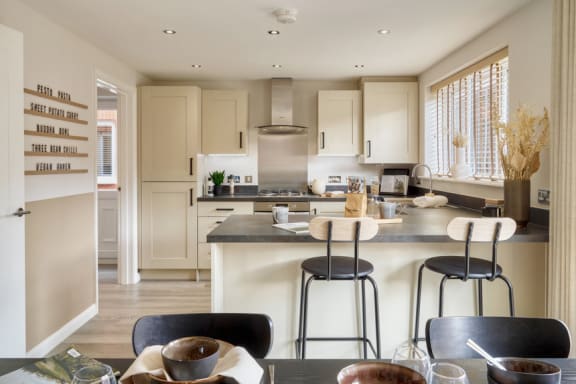a kitchen and dining area with a table and chairs