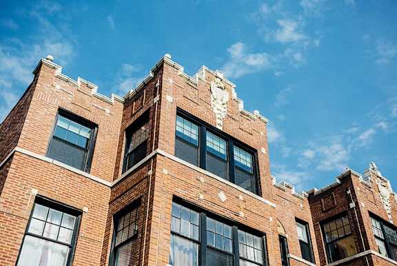 an old brick building with a blue sky in the background
