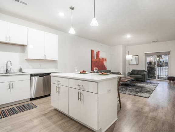 open concept kitchen and living room with white kitchen cabinets