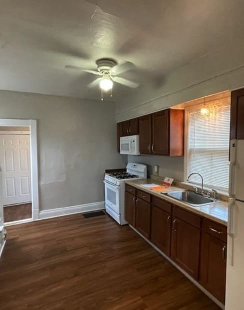 a kitchen with a refrigerator freezer and a stove top oven