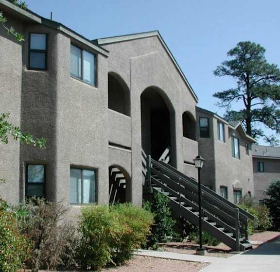 A building with a grey facade and a black staircase.