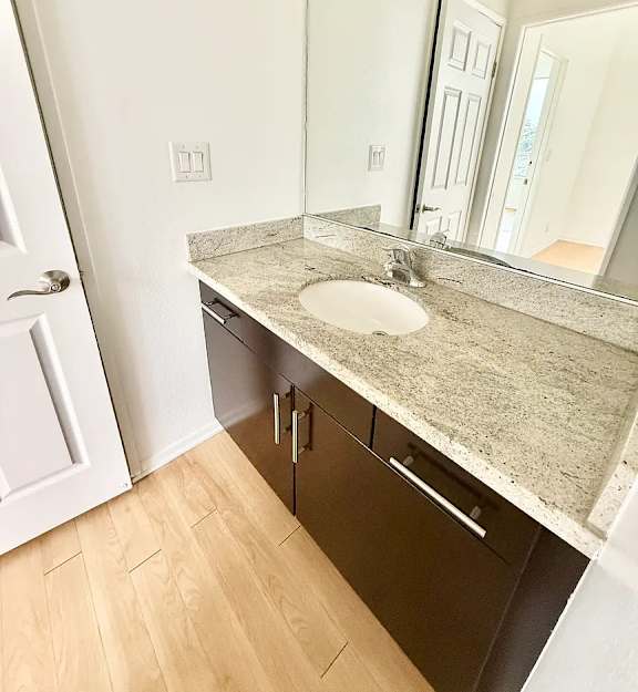 A bathroom with a sink and mirror.