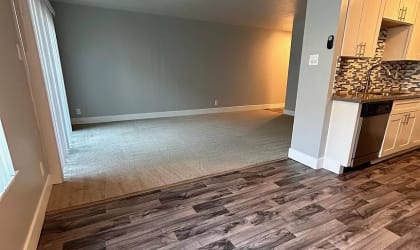 a empty living room with wood flooring in a home