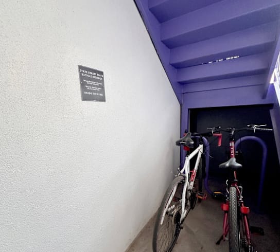 Two bikes are parked in a small room.