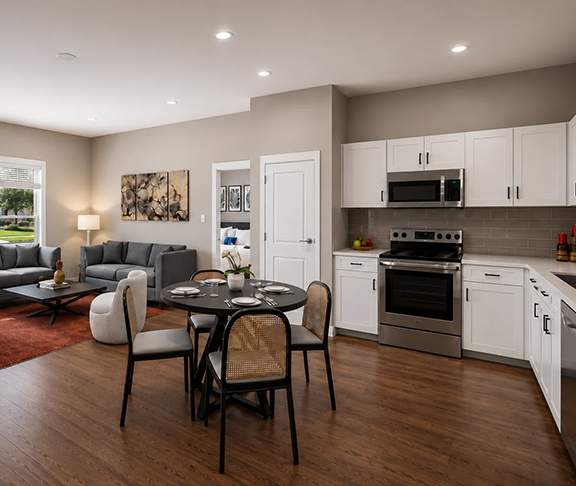 A modern kitchen with a dining table set for four.