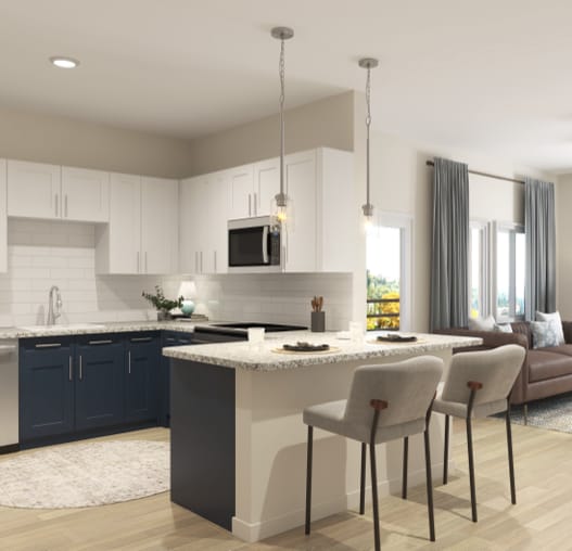 A modern kitchen with a large island and a dining area.