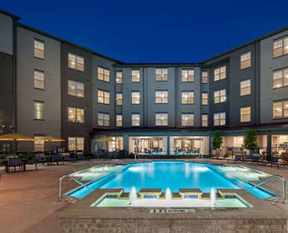 a large swimming pool in front of a building