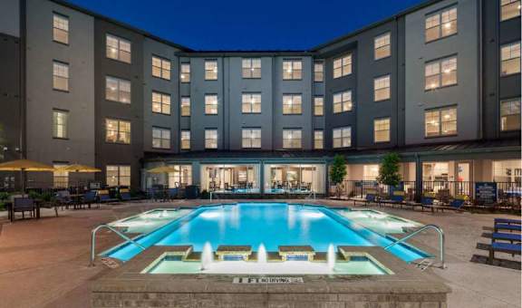 a large swimming pool in front of a building