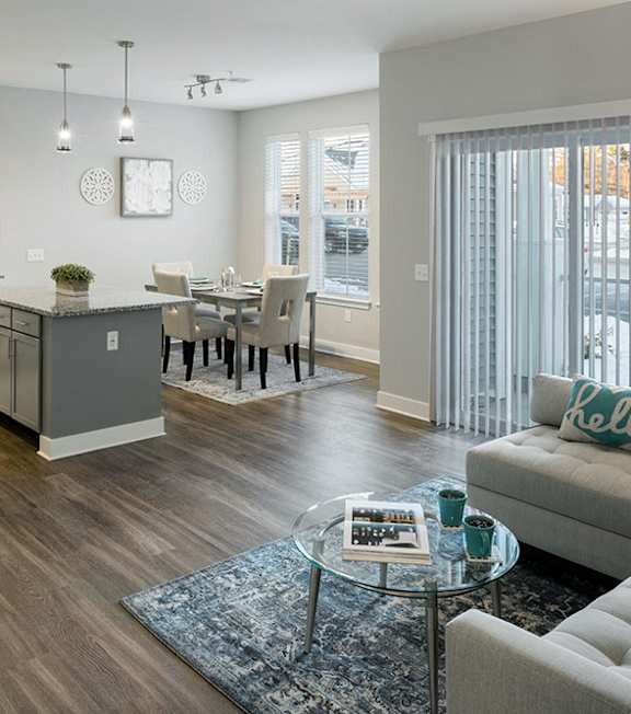 a living room and kitchen with a couch and a table at The Beacon at Gateway Apartments, Scarborough, ME, 04074