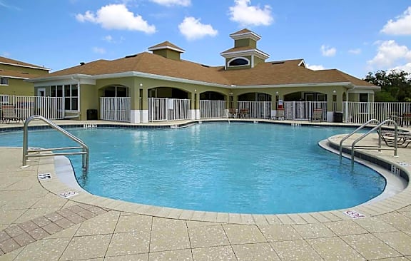 a large swimming pool in front of a house