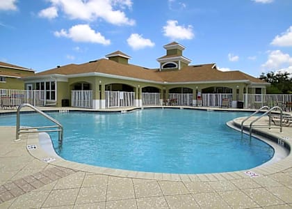 a large swimming pool in front of a house