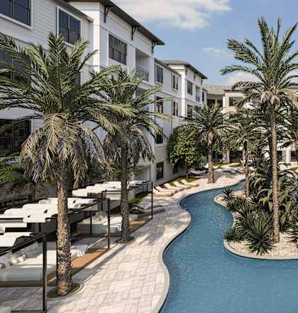 A pool surrounded by palm trees and white buildings.