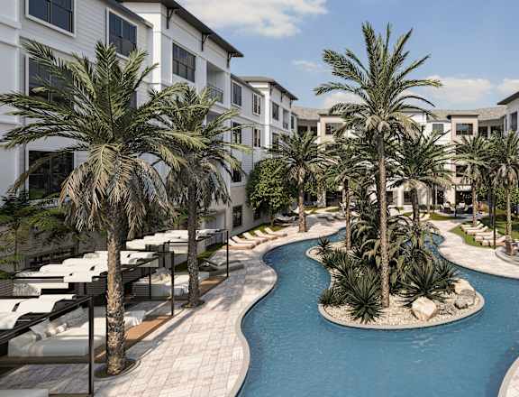A pool surrounded by palm trees and white buildings.