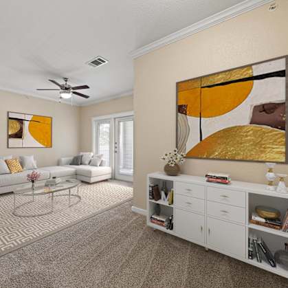a living room with white furniture and a ceiling fan