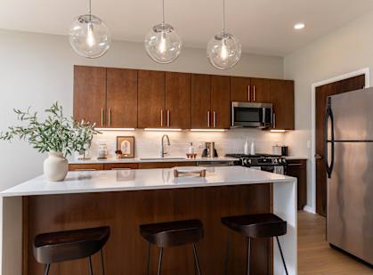 a kitchen with wooden cabinets and a white counter top