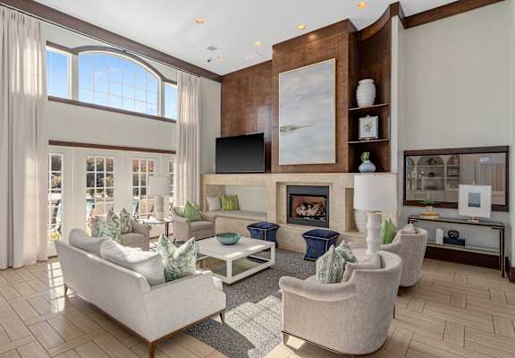 A living room with a fireplace and a large painting on the wall.