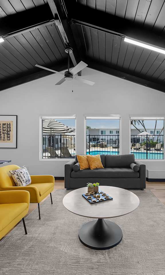 A living room with a pool view.