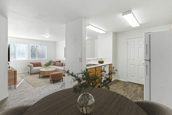 A living room with a brown table and a white refrigerator.