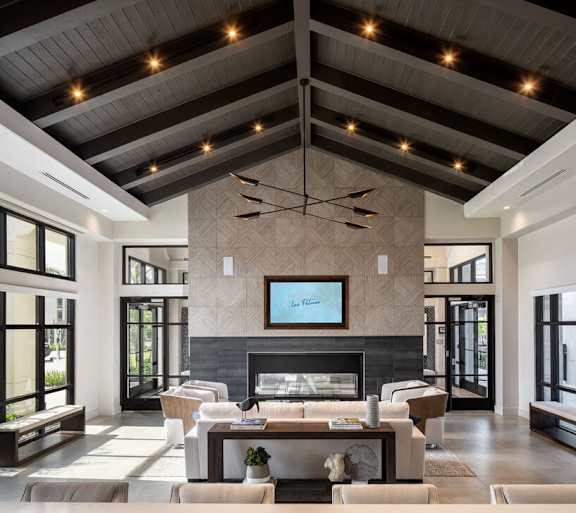 A modern living room with a fireplace and a television at Las Palmas Apartments, Fort Myers