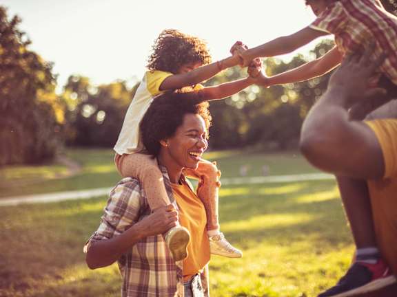 A family of four enjoying a sunny day outdoors.