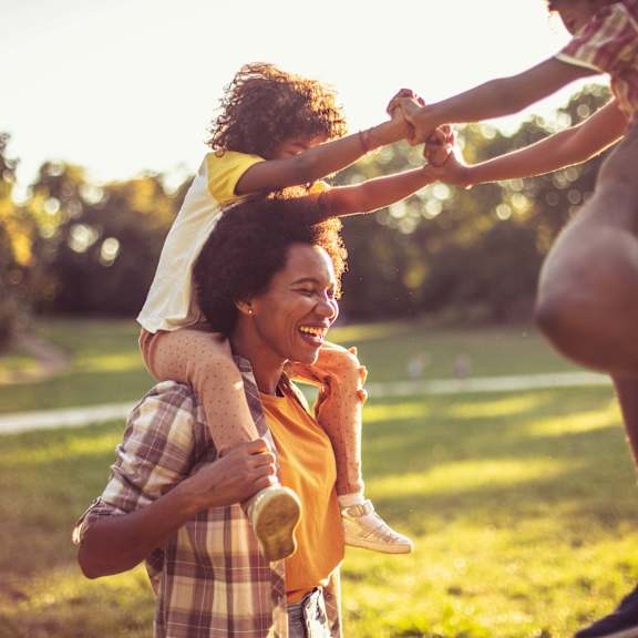 A family of four enjoying a sunny day outdoors.