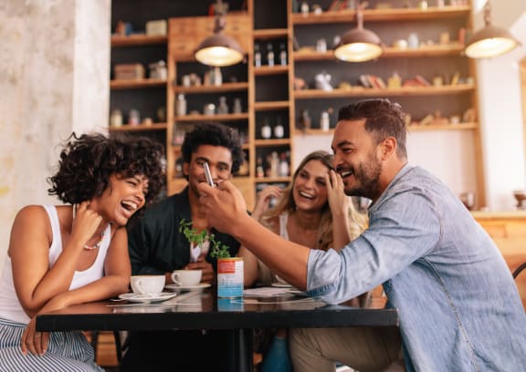 a group of people sitting at a table in a restaurant
