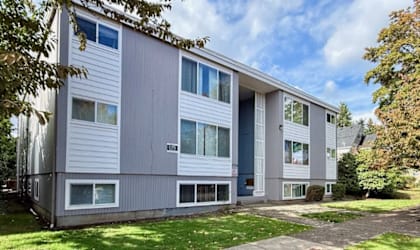 A modern two-story building with a grey and white exterior.