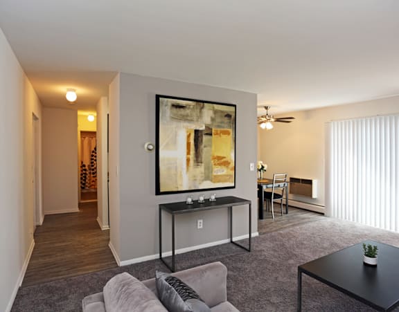 a living room with a couch and a coffee table in front of a large window