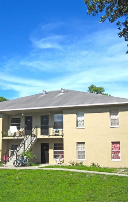 A two-story building with a balcony on the second floor.