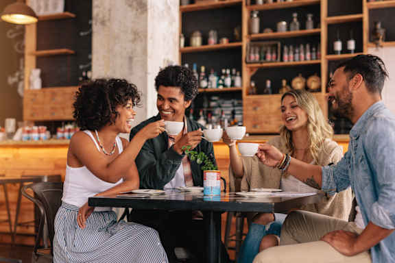 Four people are sitting around a table in a restaurant.