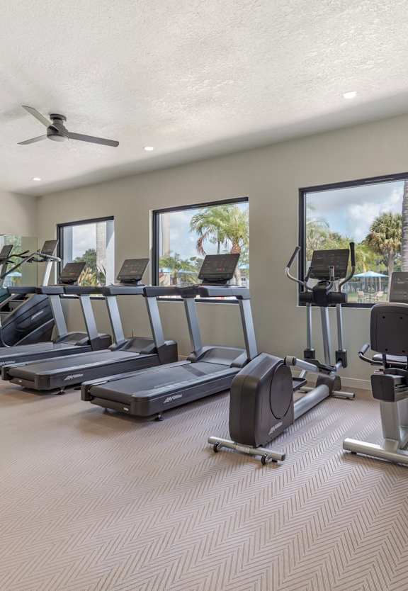 a gym with weights and cardio equipment at the enclave at woodbury at Gateway Club, Florida, 33436