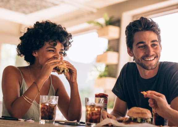 a man and woman sitting at a table eating food at Hibernia Apartments, St Louis, Missouri