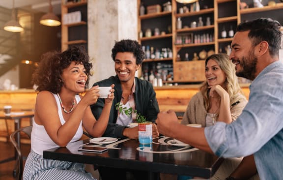a group of people sitting at a table in a restaurant at The James at Chatham Hills, Westfield, IN