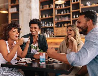 Four people are sitting at a table in a restaurant.